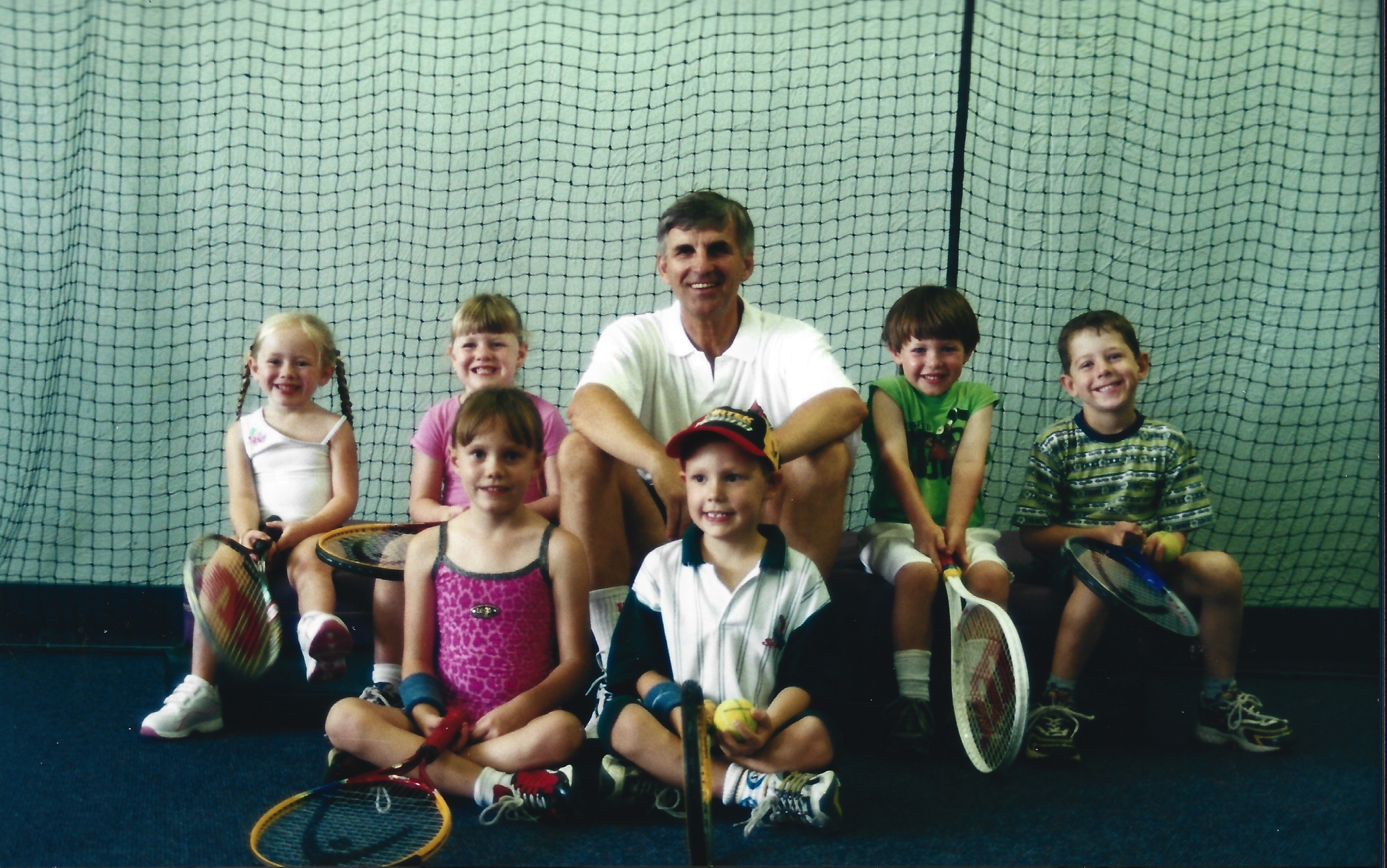Teddy's Toddler Tennis, Teddy sitting with toddlers on a tennis court